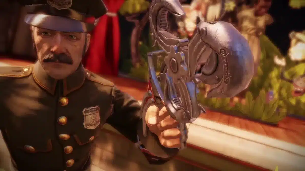 A uniformed police officer with a moustache points an ornate, mechanical weapon towards the camera, with a blurred crowd and stage in the background.