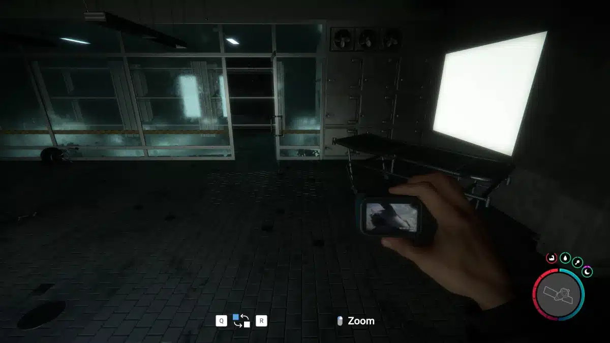Player holding the Action Cam inside a dark bunker room in Sons of the Forest.