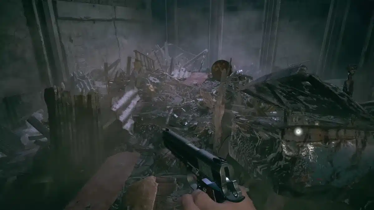A chaotic scene in Heisenberg’s Factory with scattered rubble and a handgun in the foreground pointing at the debris.