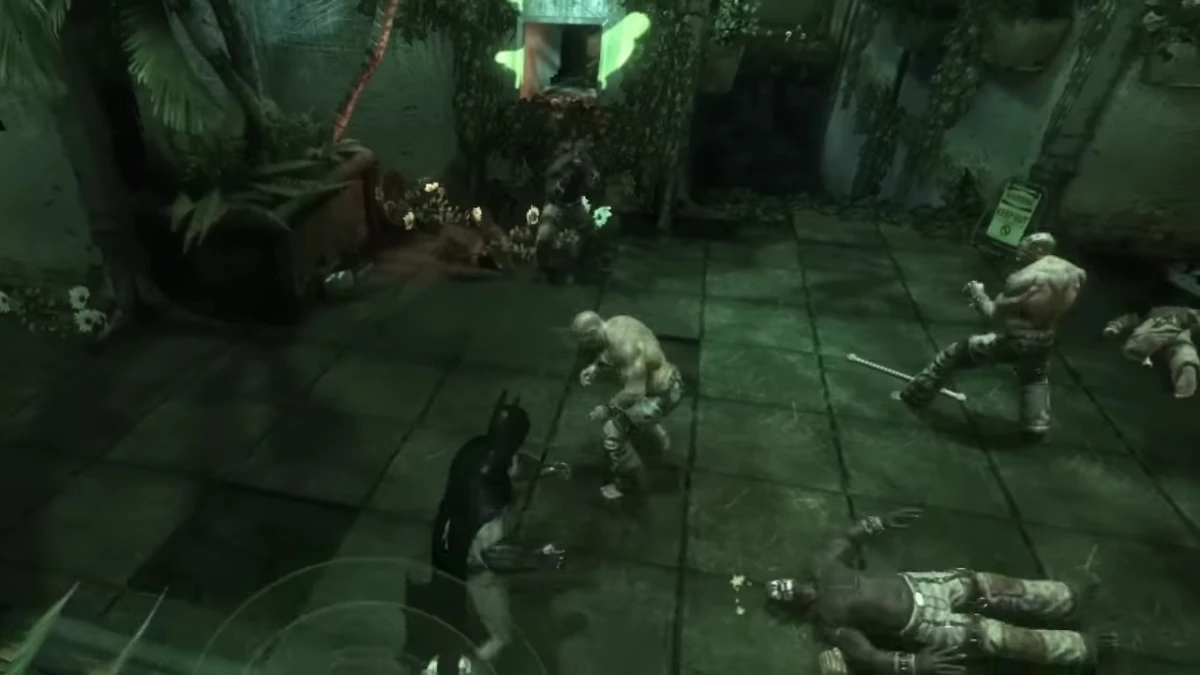 Batman fighting inmates inside Arkham Asylum during a combat encounter