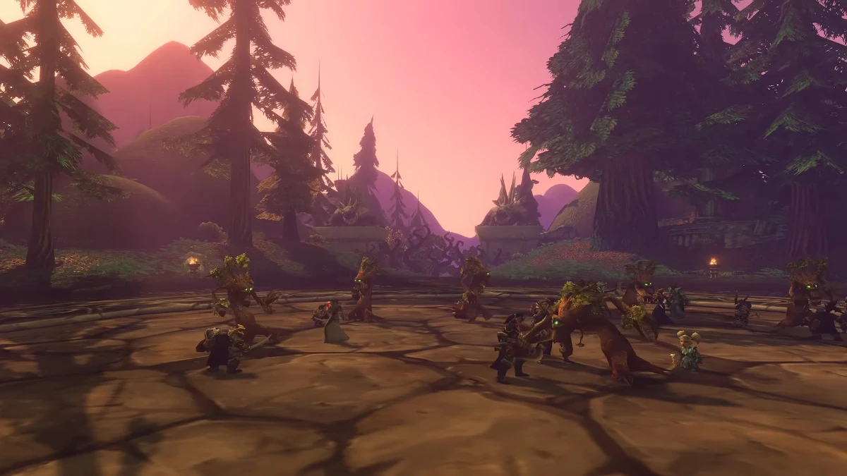 A group of small, tree-like creatures with glowing green eyes gather in a circular, stone-paved clearing surrounded by large pine trees and distant, hazy mountains under a soft pink sky.