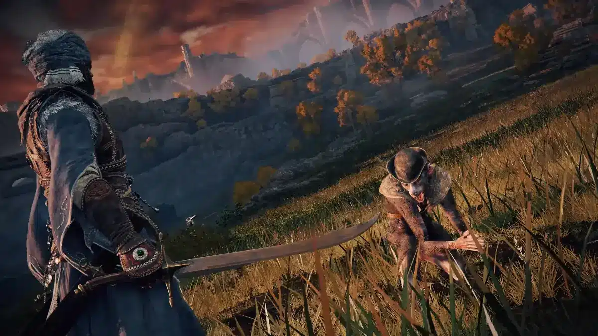 A warrior in blue robes and a turban draws a curved sword, facing a small, hunched creature with pale skin and a hat in a grassy, autumnal landscape under a dramatic orange sky.
