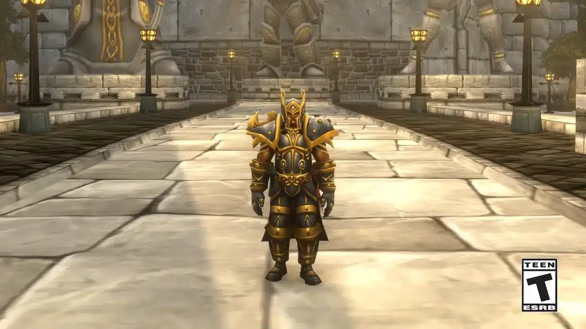 A character in ornate black and gold armor stands on a stone pathway in front of a large stone statue and ornate streetlights.