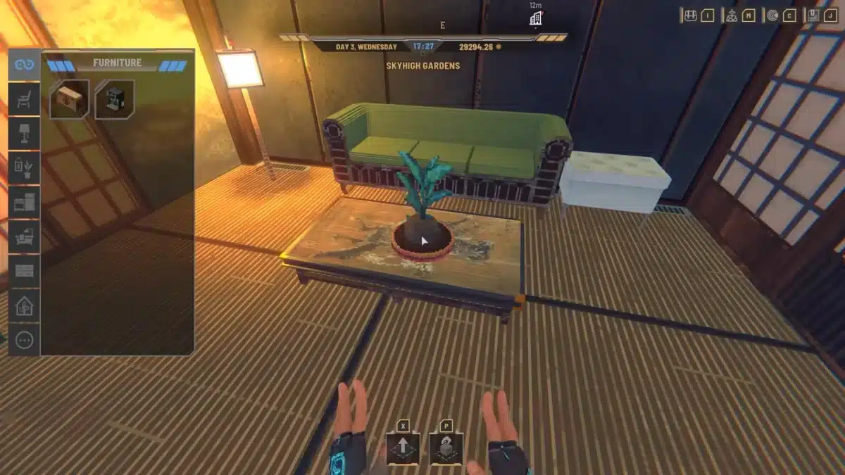 A video game interface shows a furniture selection menu on the left and a view of a room with a green couch, a wooden coffee table with a potted plant, and a white storage box.