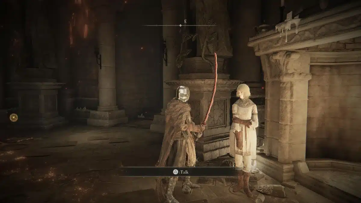 A warrior in ornate armor holding a curved sword stands facing a woman in a white dress within a dimly lit, stone interior.